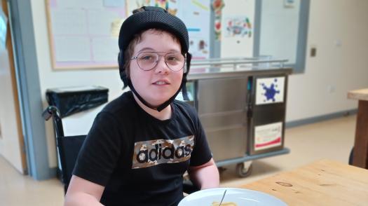 Riley smiling at the camera