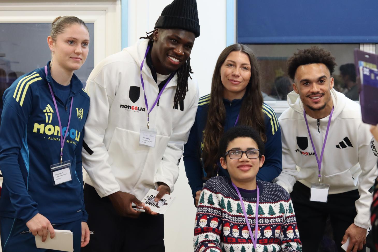 Child smiling with Fulham players