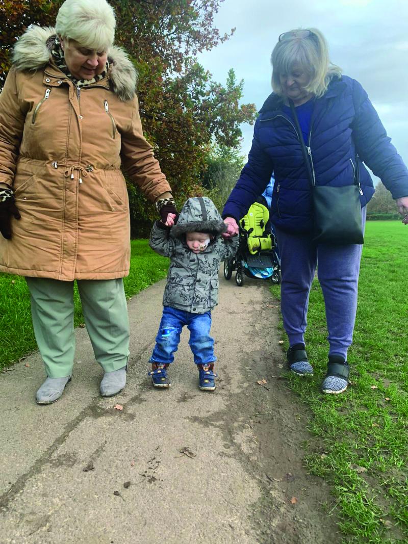 Kaden walking with his family
