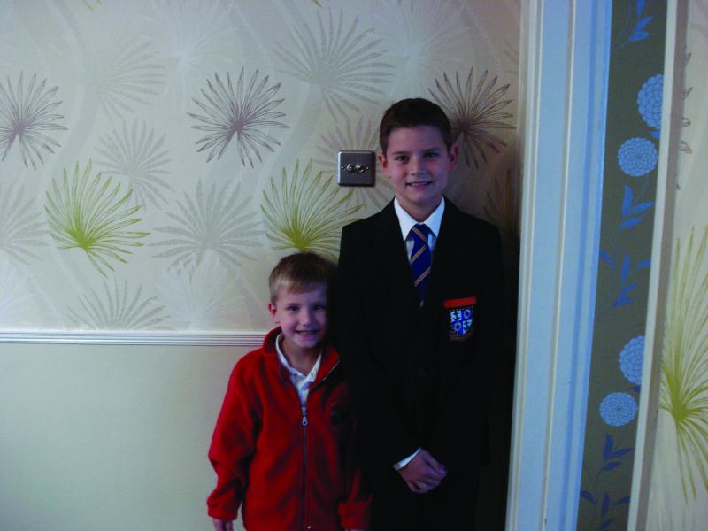 Riley in school uniform with his brother