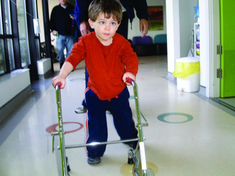 Tommy with a walker at The Children's Trust