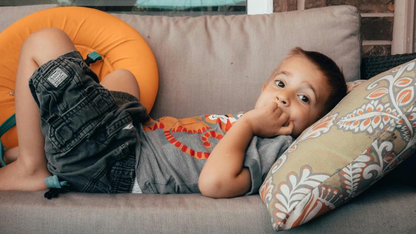 Boy resting on a sofa