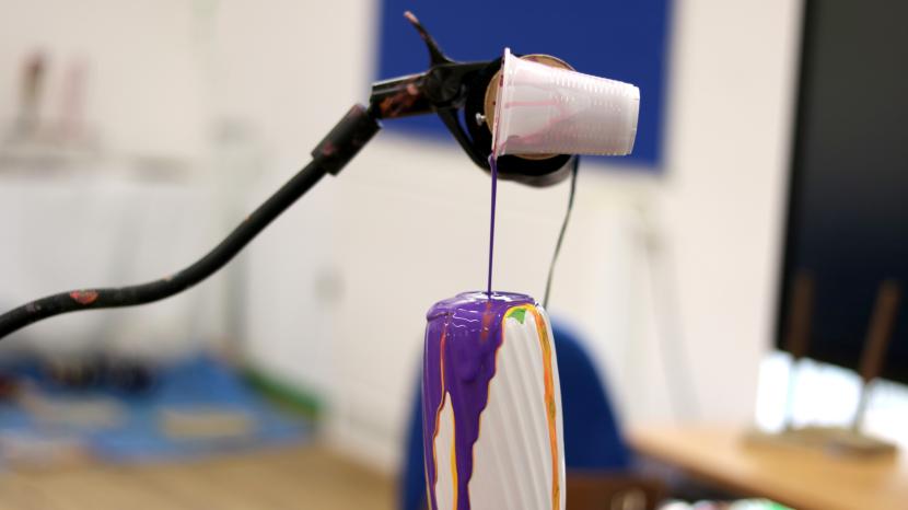 Accessible arts activities using equipment to pour paint onto a vase